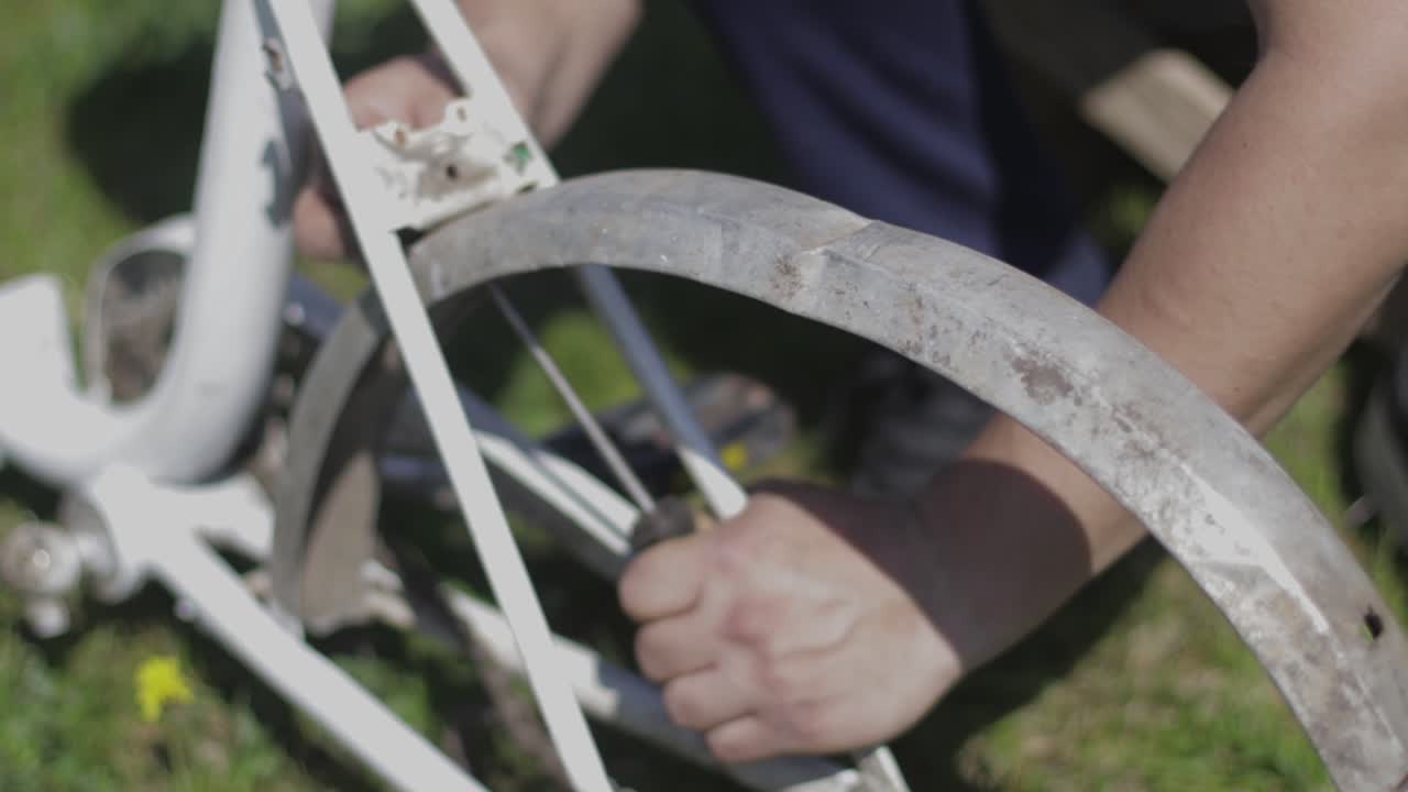 Repairing an old bike. Restoration of a bicycle. Parts of a bike. Bicycle mechanic fixing a bike.