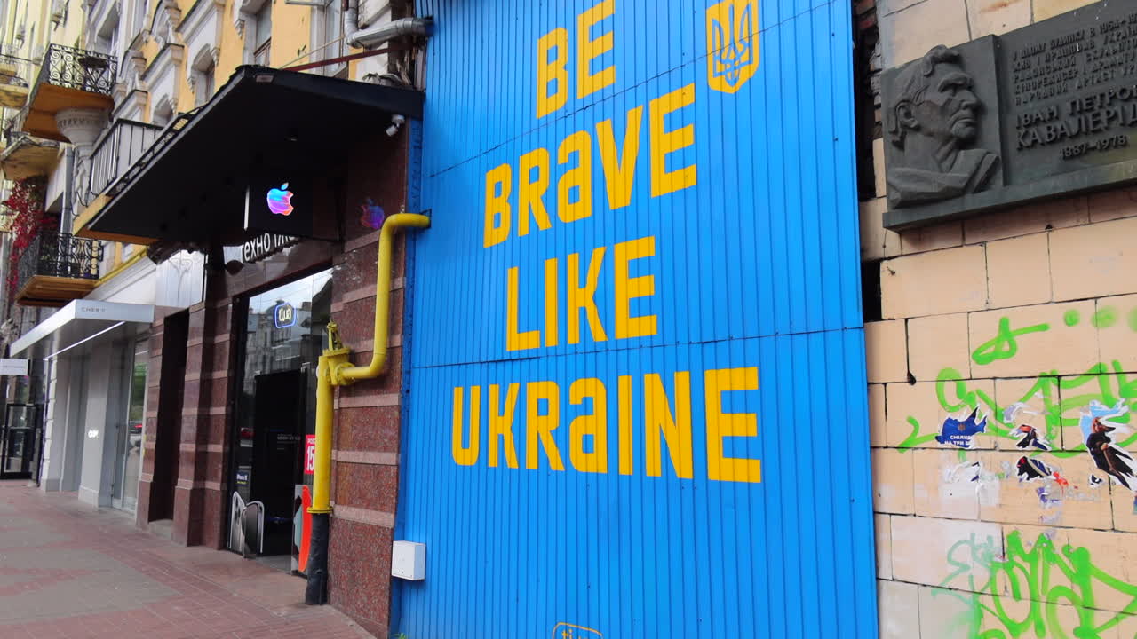 Blue and yellow sign Be Brave Like Ukraine in Kyiv city center, 4K shot