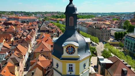 4k aerial drone video of the historic herrieder clock tower in the old town area of downtown ansbach, germany