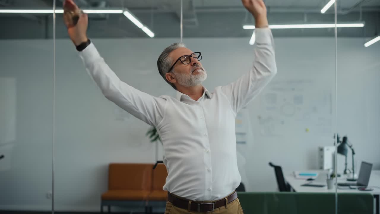 A professional man engaged in a stretching exercise within a modern office environment, promoting wellness and productivity through simple physical movements