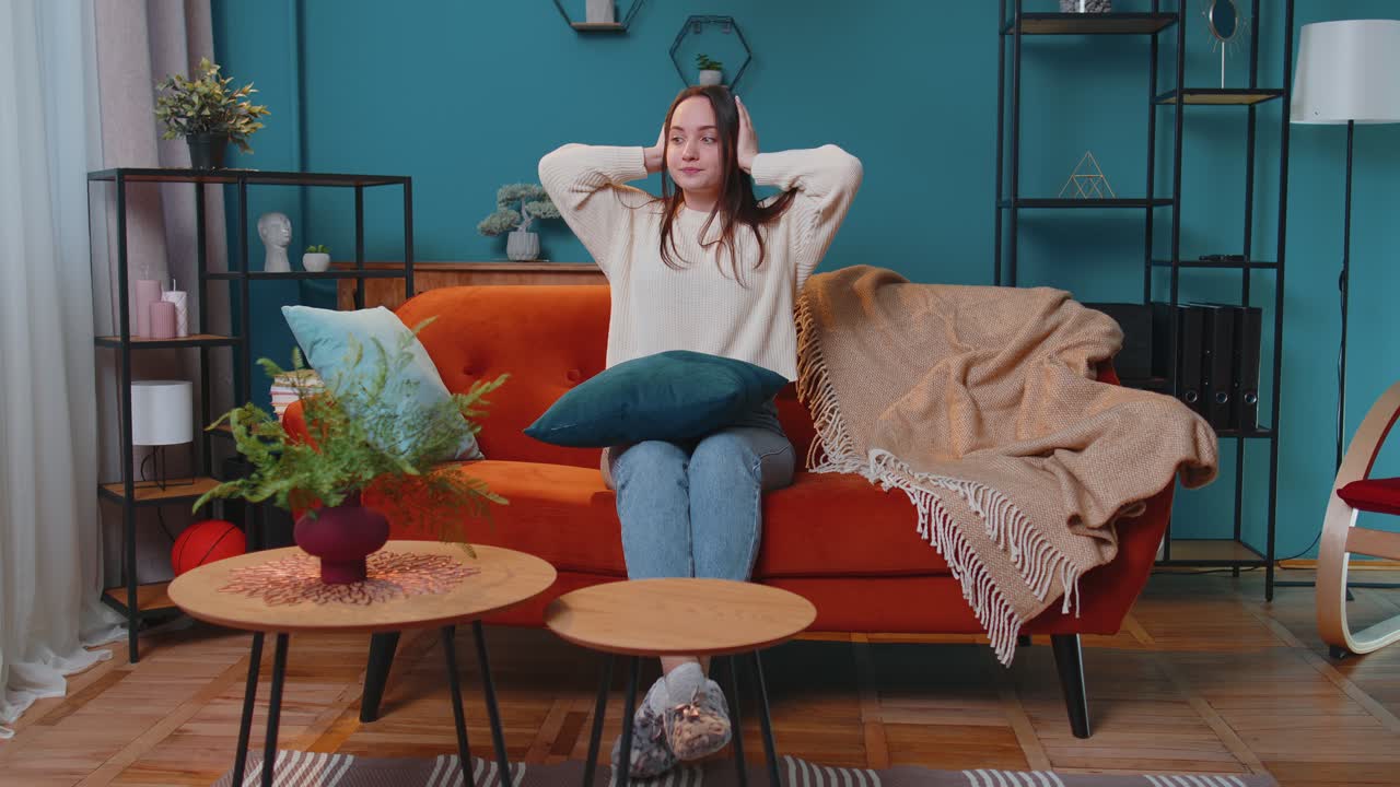 Repair work at neighbours concept irritated woman at home cover ears with hands annoyed by noise