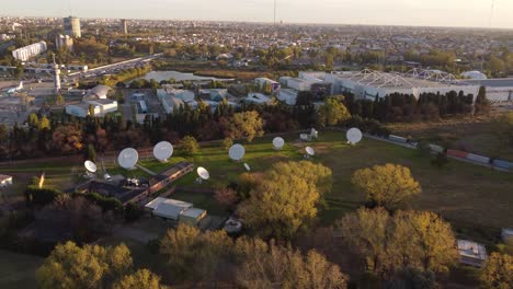 aerial view showing many white circular antennas in research center of buenos aires during sunset