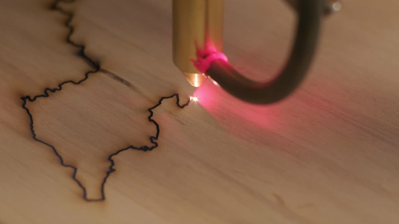 Cnc laser cutting machine cuts wooden plank and plywood