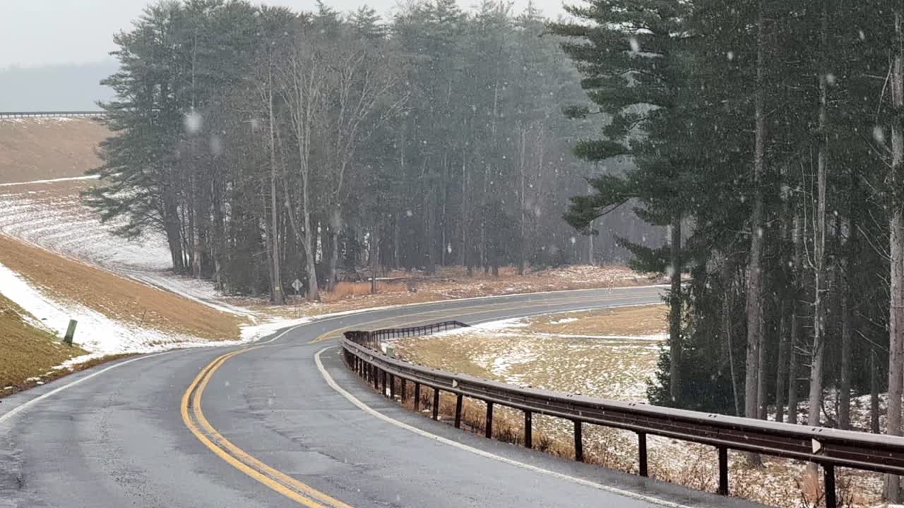 Gentle, beautiful snowfall at the beginning of of a big nor’easter on a road in the Catskill mountains – slow motion