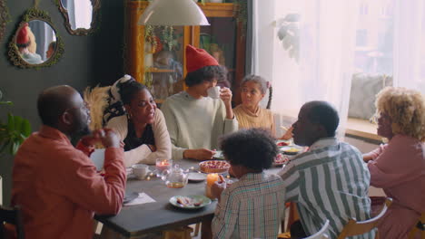 large family having holiday dinner and speaking