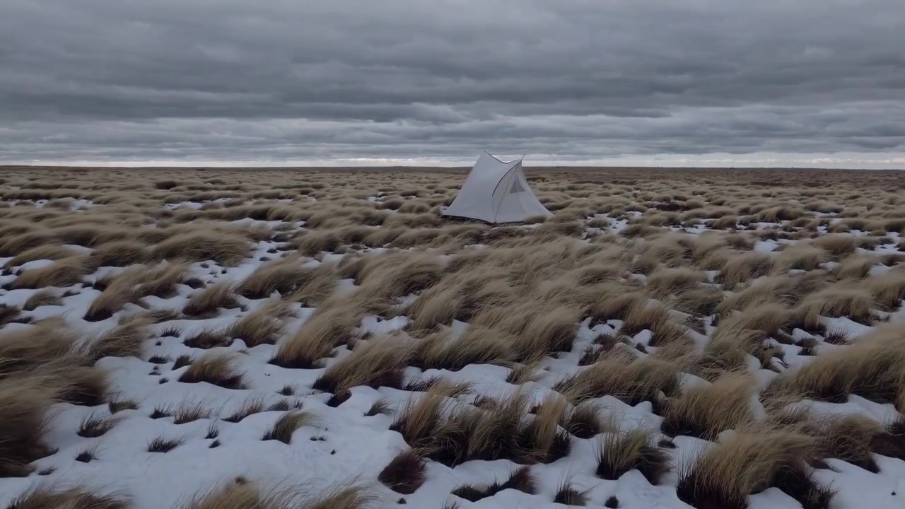 White Tent Standing in Snowy Tundra Landscape
