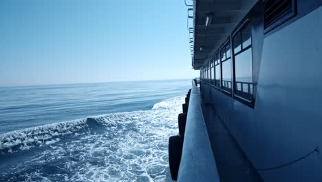 on the side of a boat, looking toward the horizon