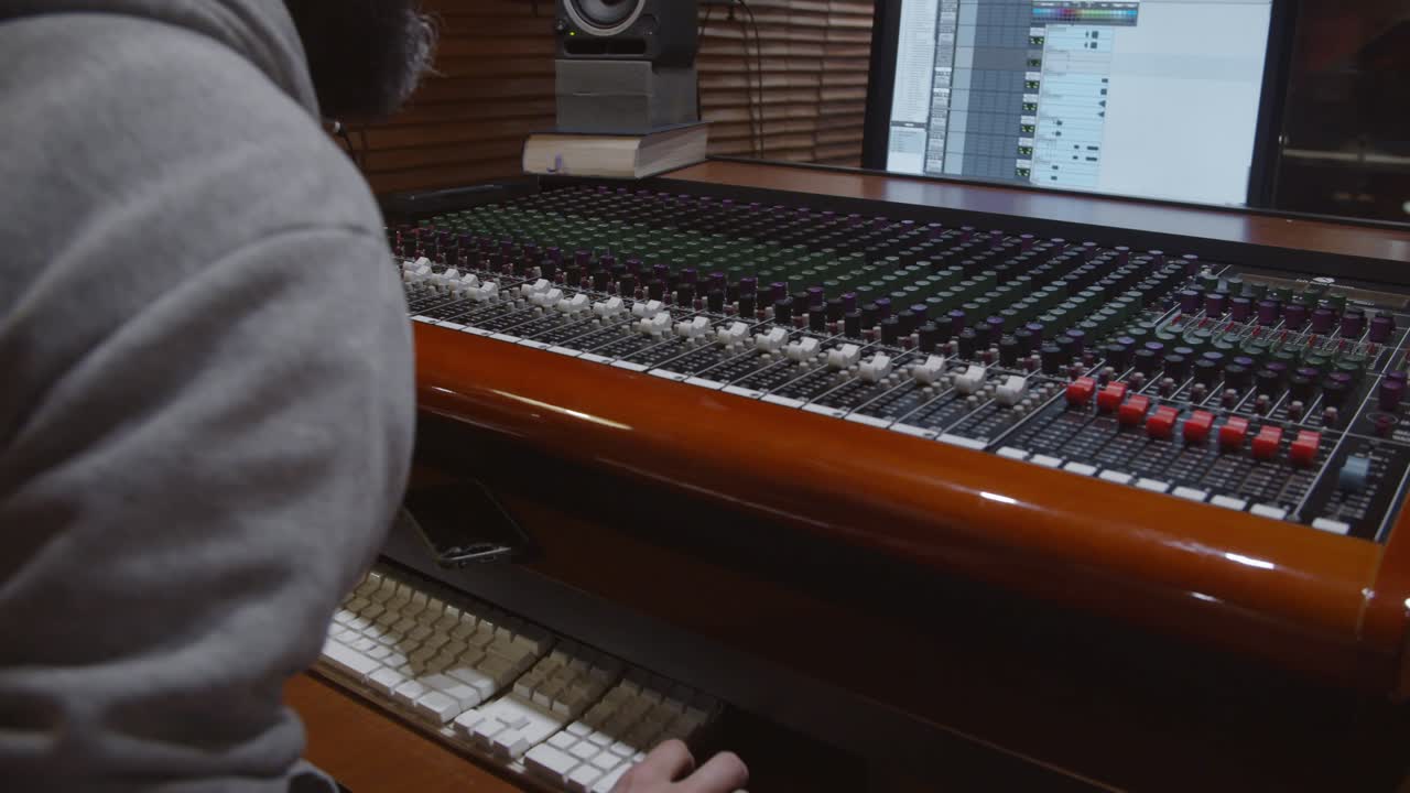 Man in a control room of a recording studio making a mix with a Toft console - Professional recording studio - 4K at 60fps (slowmotion) - Professional audio vives