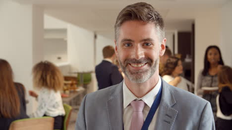 Portrait-Of-Male-Delegate-During-Break-At-Conference