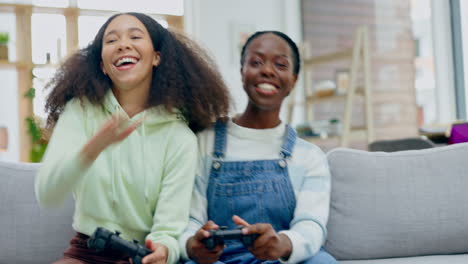lesbian women, gaming and controller on sofa