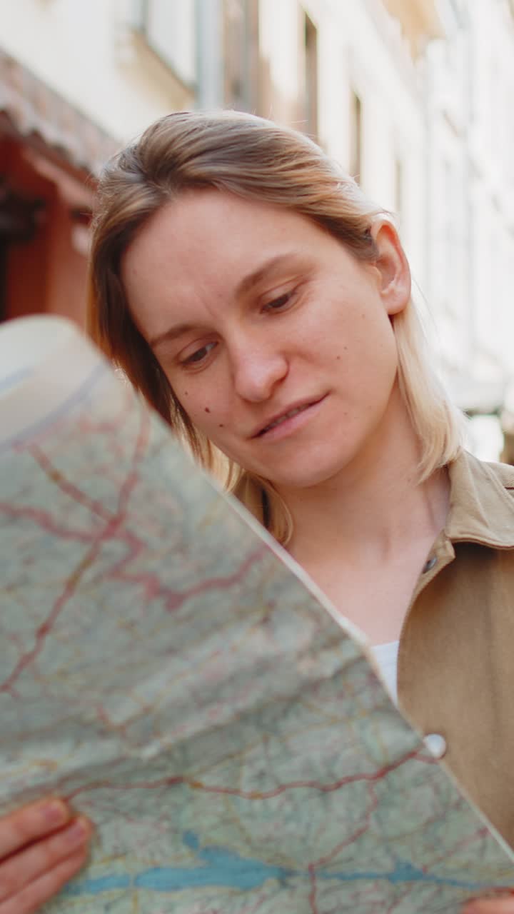Woman traveler lost while traveling in city exploring sightseeing map looking way destination