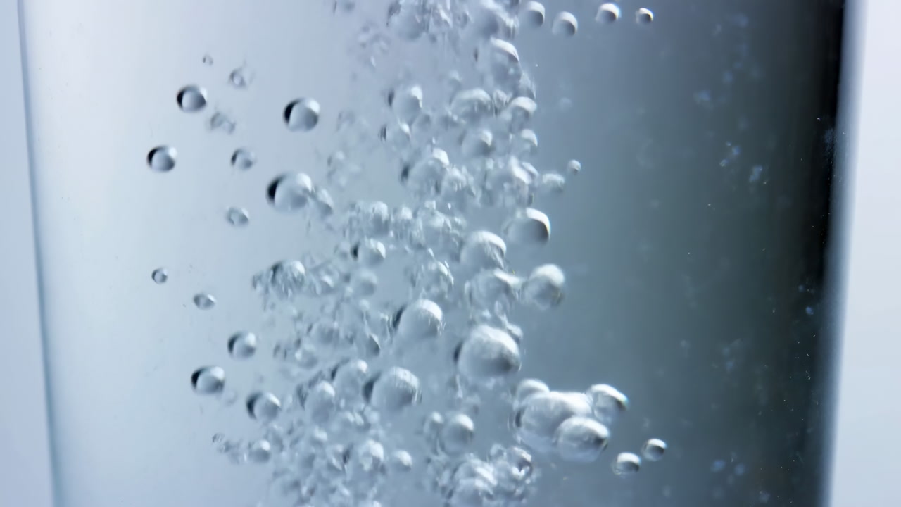 Macro Bubbles Rise Through Clear Water, Glass Vessel Reveals Effervescence And Fizz, Sparkling Reflections,