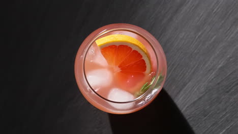 refreshing grapefruit cocktail with ice and rosemary