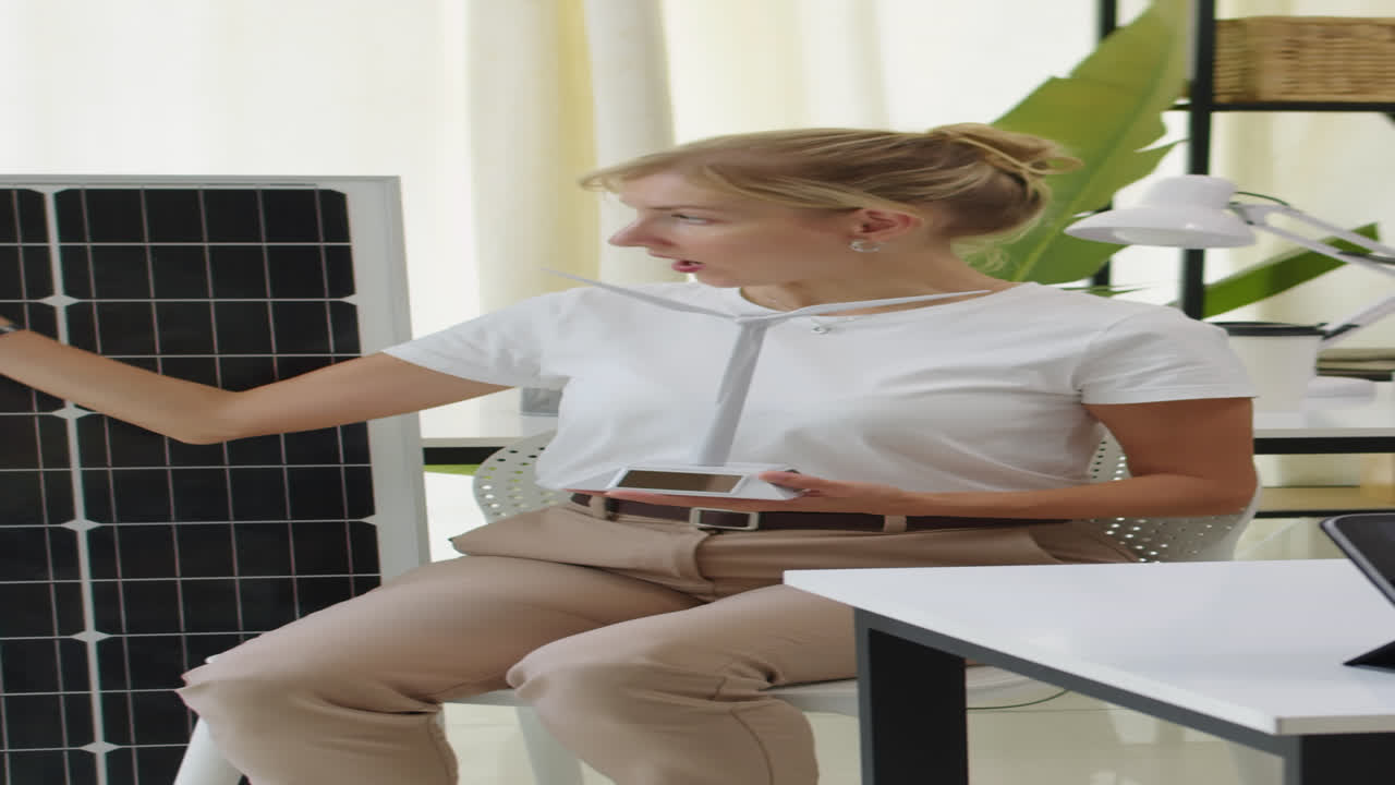 Specialist Talking on Wind Turbines and Solar Panels in Green Office