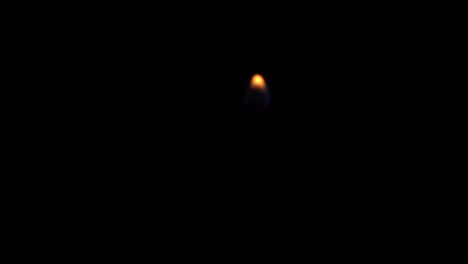 hand holding a match igniting out of focus