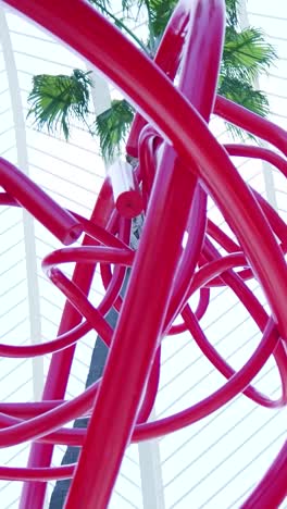 abstract red sculpture in urban setting