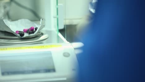 doctor checks for average weight of capsule in the laboratory