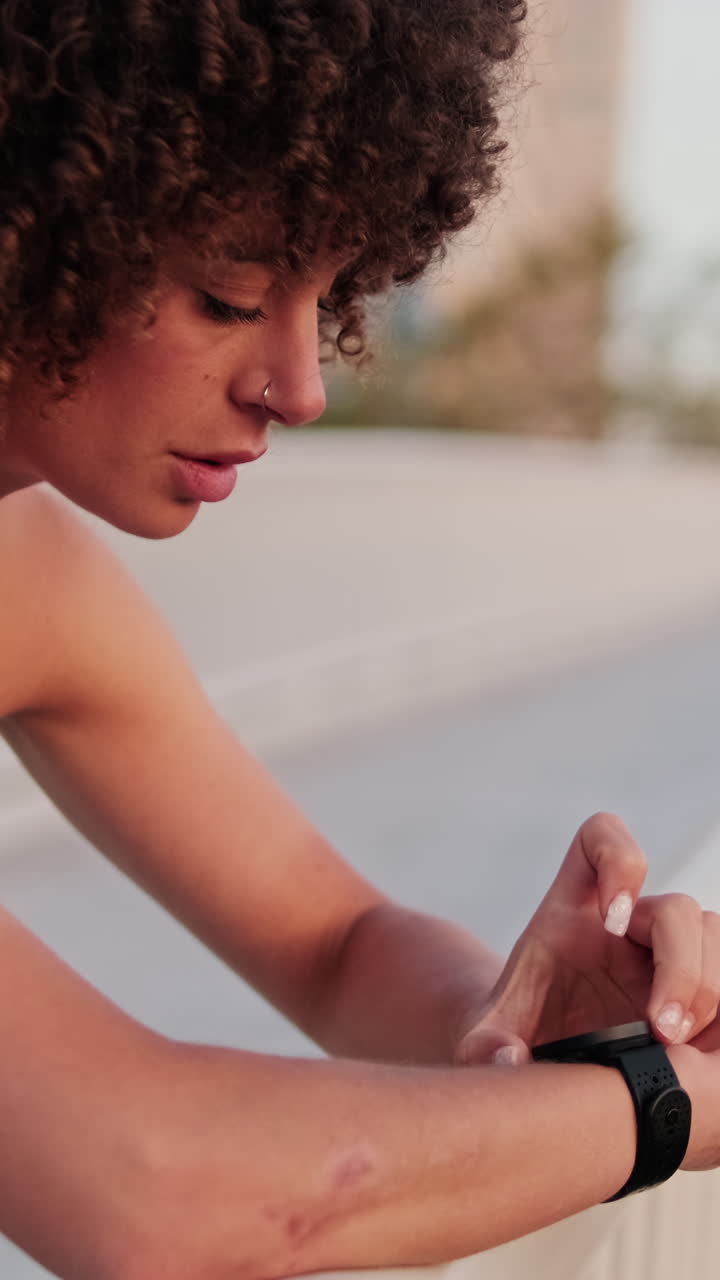 Fit Woman Checks Smartwatch During Workout