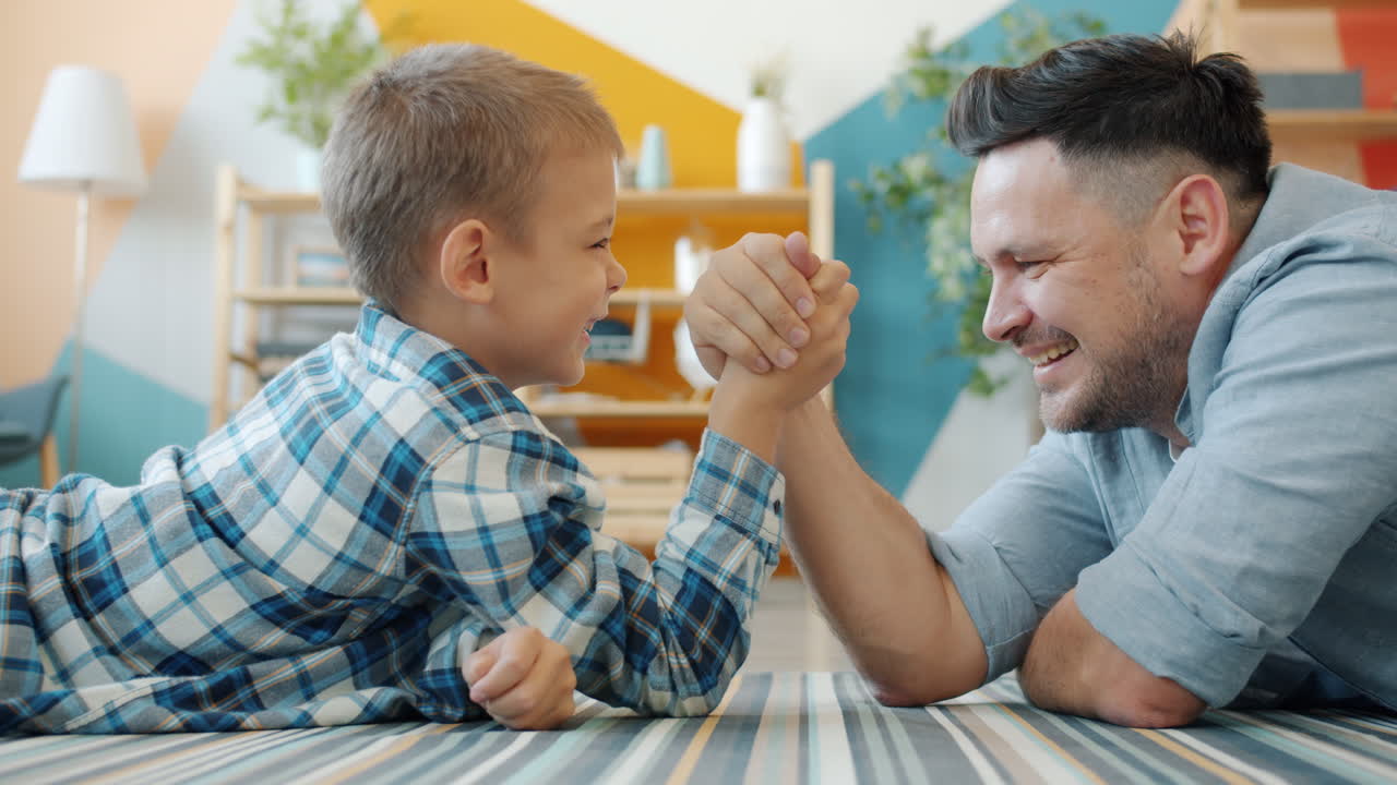 Father and Son Arm Wrestling at Home