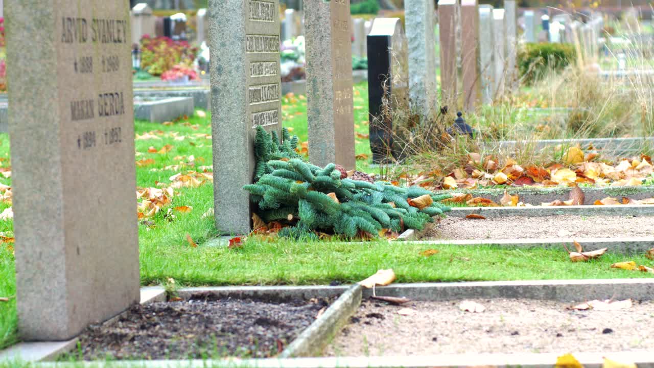 Tombstones in Kviberg Cemetery in Gothenburg, Sweden -slow panning and focus pull
