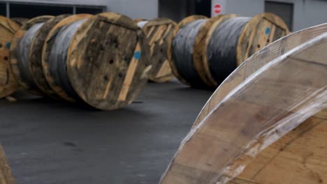 large wooden cable spools on-site cable plant. the bay with a cable prepared for loading on the cable plant.