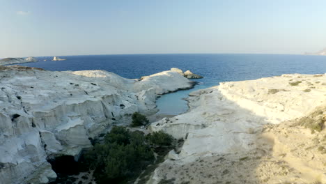 low cinematic aerial drone footage of sarakiniko beach in milos island, greece at sunset in 4k