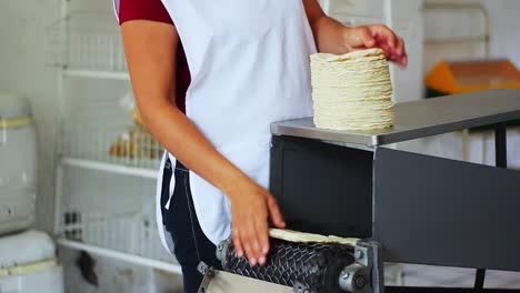 Corn-tortillas-stacked-by-woman