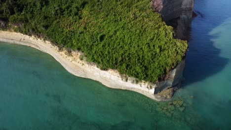 aerial of corfu island rocky cliff coastline with clean sea water , holiday travel destination in mediterranean europe