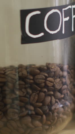 video of jars with diverse type of coffee standing on shelf at coffee shop