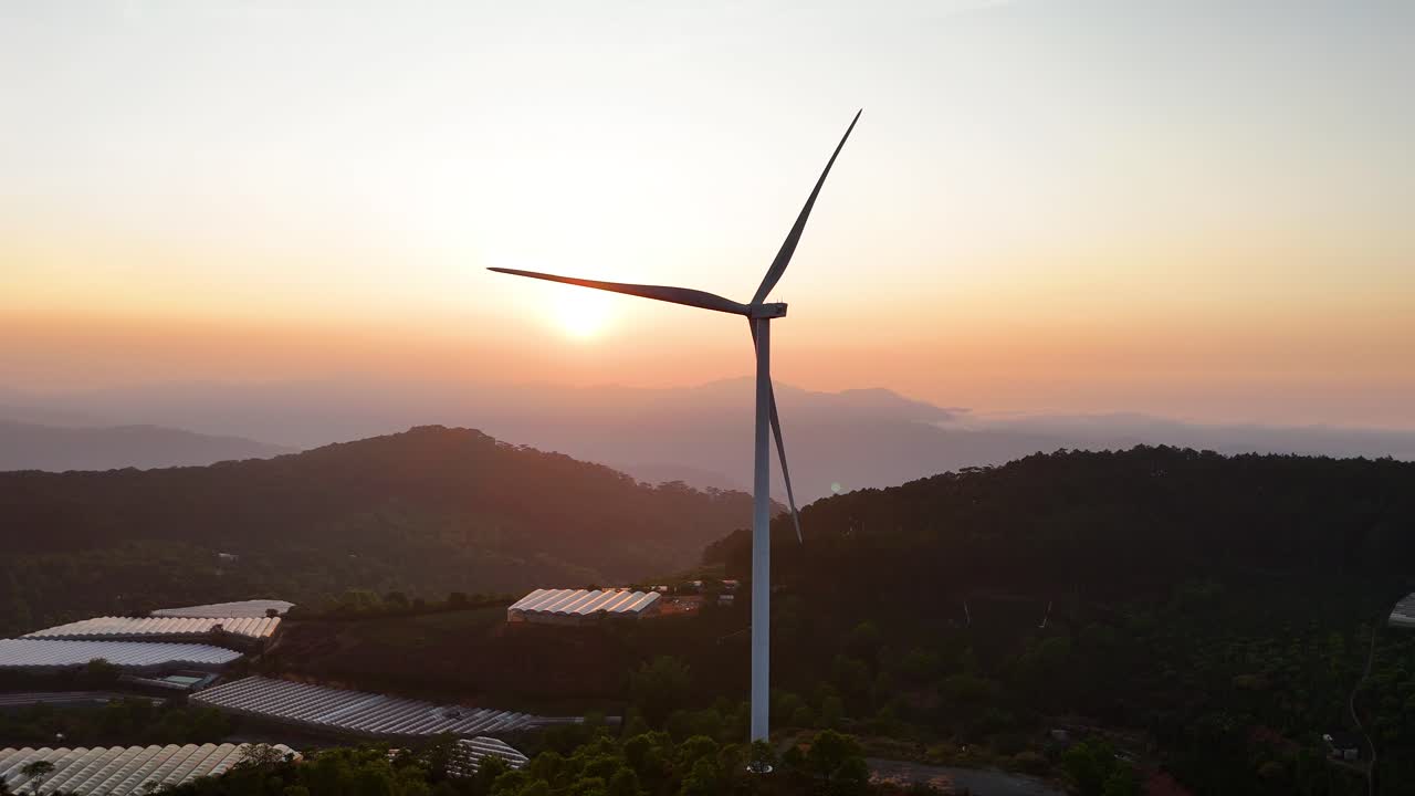 Wind power hill with rotating blades in the brilliant morning sunlight in Da Lat - Vietnam | Wind power