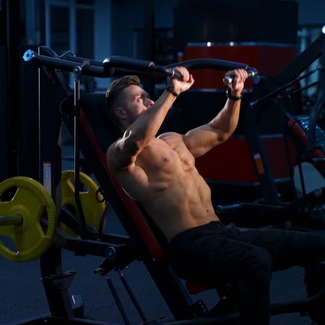 fit young man lifting barbells doing workout at a gym. sport, fitness, weightlifting, bodybuilding, training, athlete, workout exercises concept. view from the side