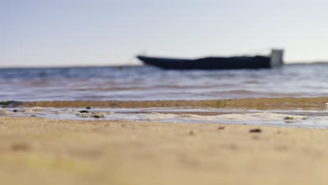 sand beach and boat or ship on sea in blurry background, copy space for titles