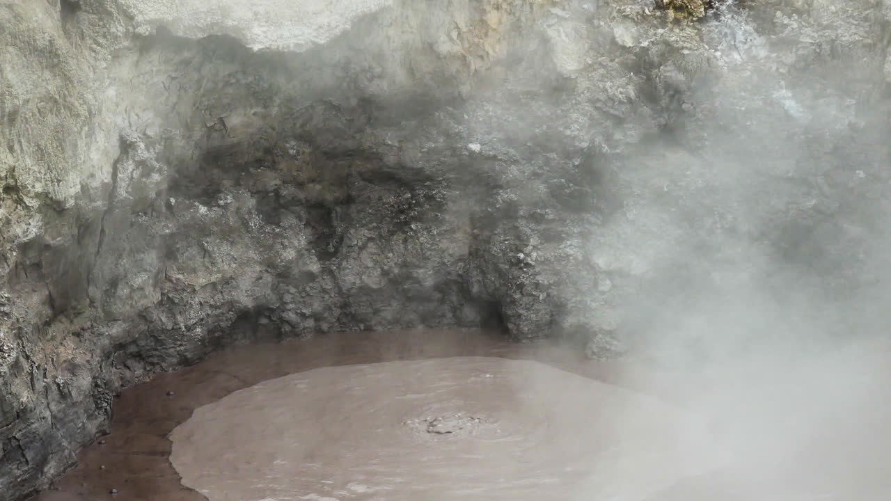 Close up shot of Hot Pool with rising Steam In Geothermal Wonderland Wai-O-Tapu, Rotorua, New Zealand