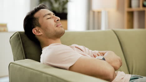 man sleeping on a sofa