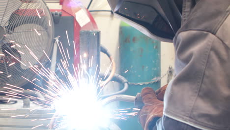 closeup shot of worker welding in a industrial metal workshop