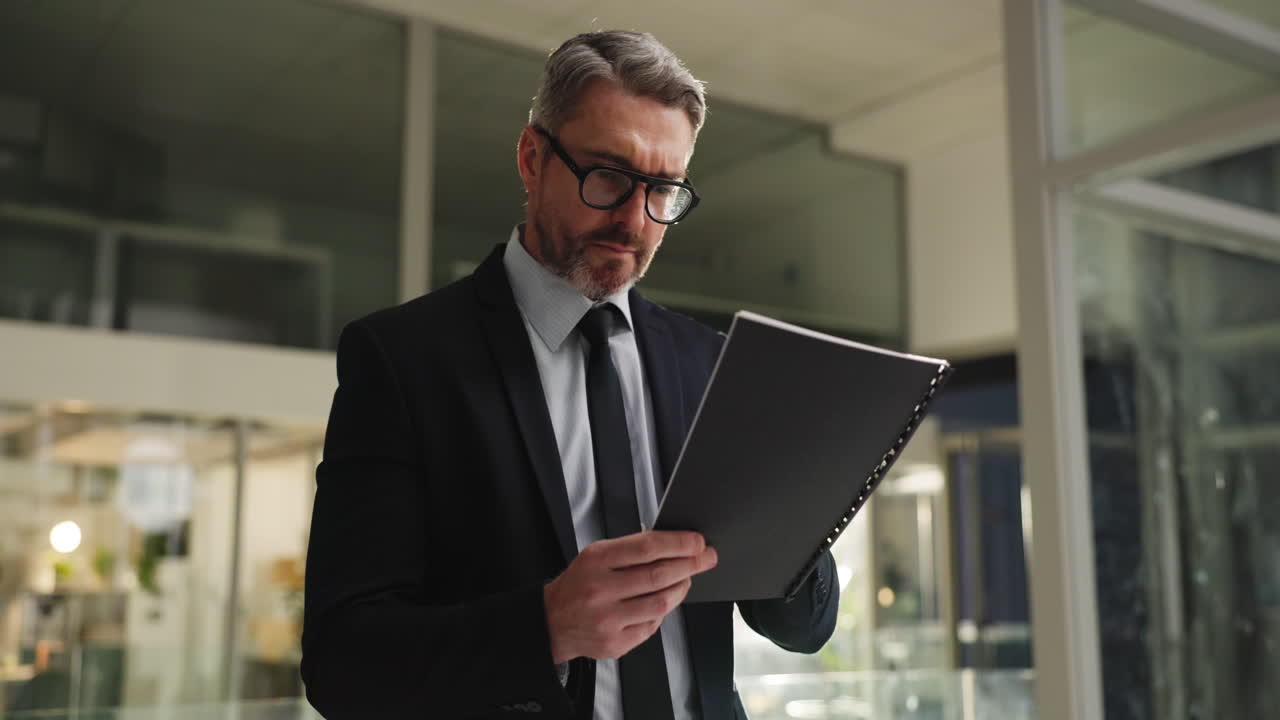 Businessman Reading Report in Office