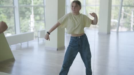 young girl breakdancing in modern studio