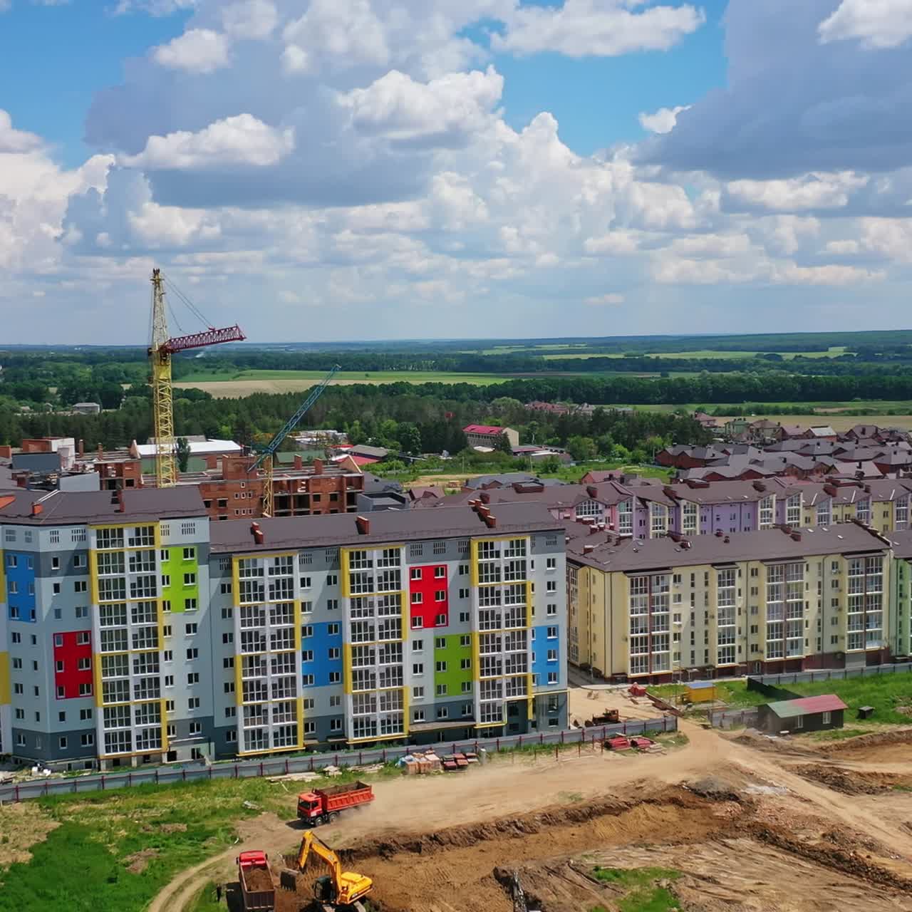 New construction site on nature background. High rise buildings in construction area. Construction works in the outskirts of a city