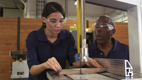 carpenter and female apprentice using jigsaw shot on r3d