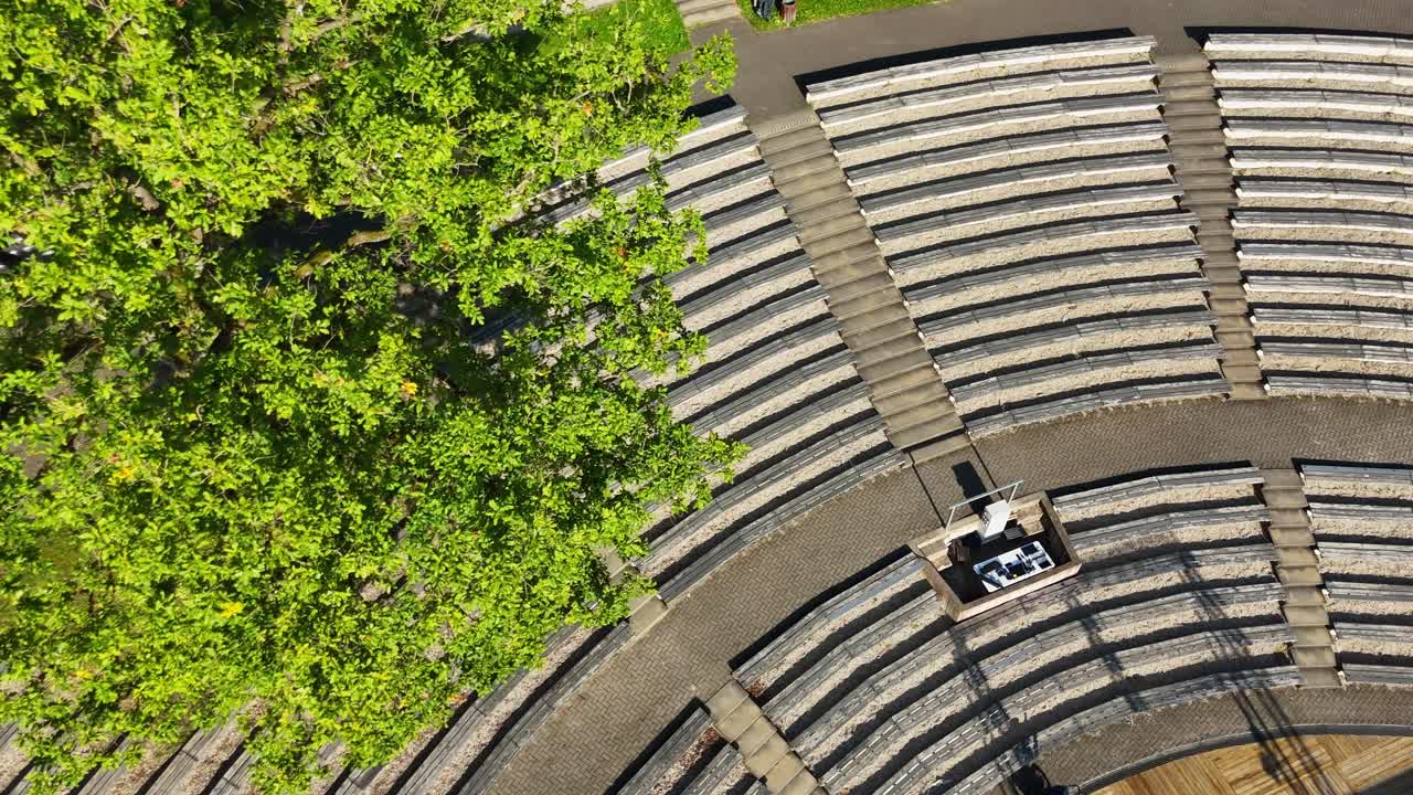 Aerial view of Talsi amphitheater with lush trees on a sunny day