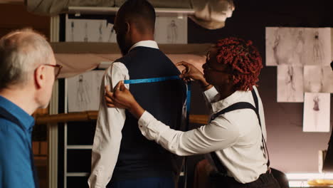 Tailors-team-take-measurements-on-client