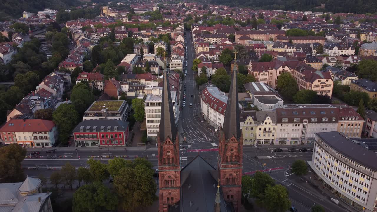 Aerial view of catholic church Johanneskirche in center of gothic old town of Freiburg im Breisgau during sunset, Germany