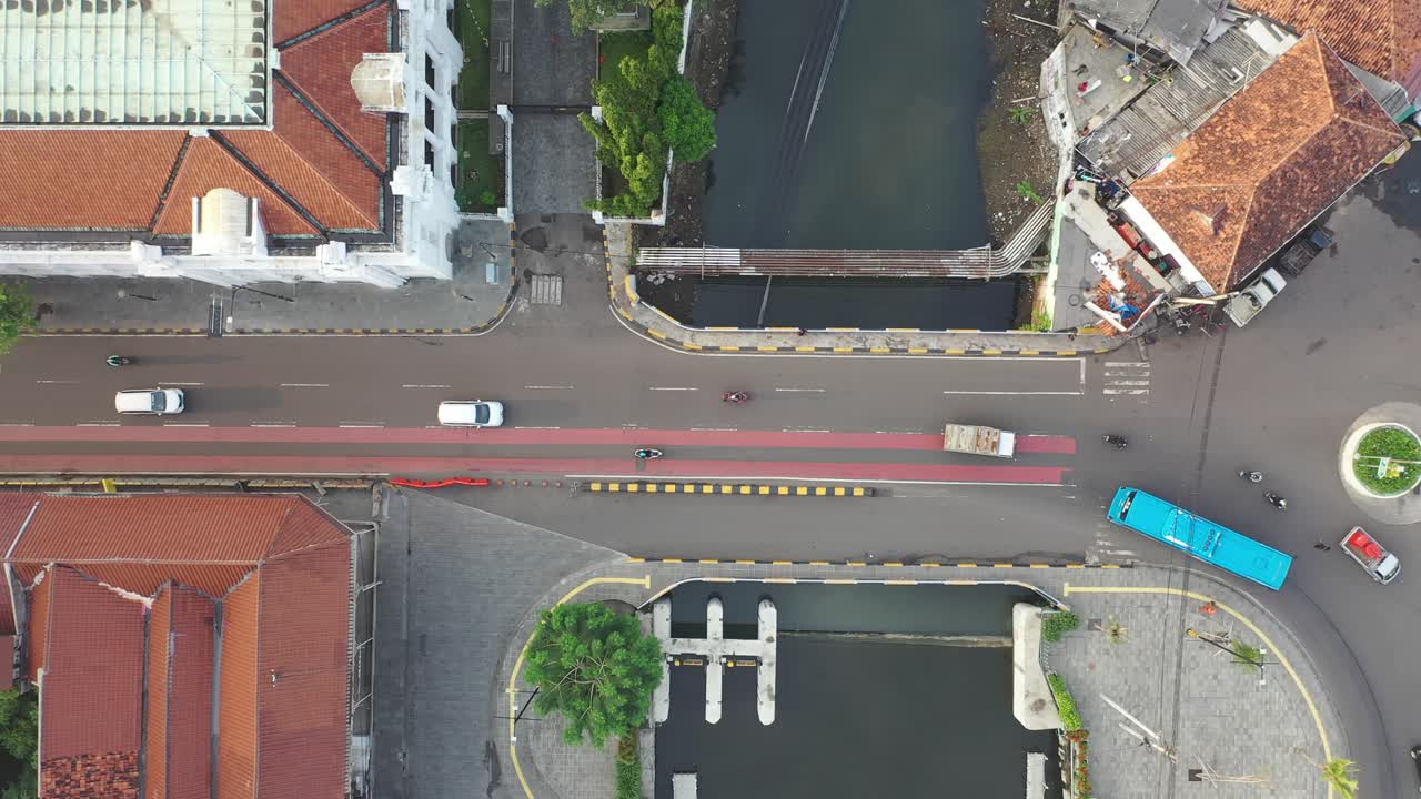 Aerial view of a city intersection with canal and bridge