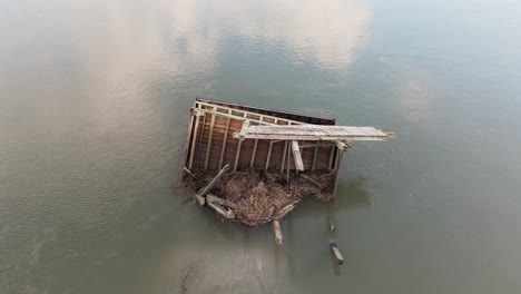 orbiting drone shot of broken dock in pawleys island after hurricane ian