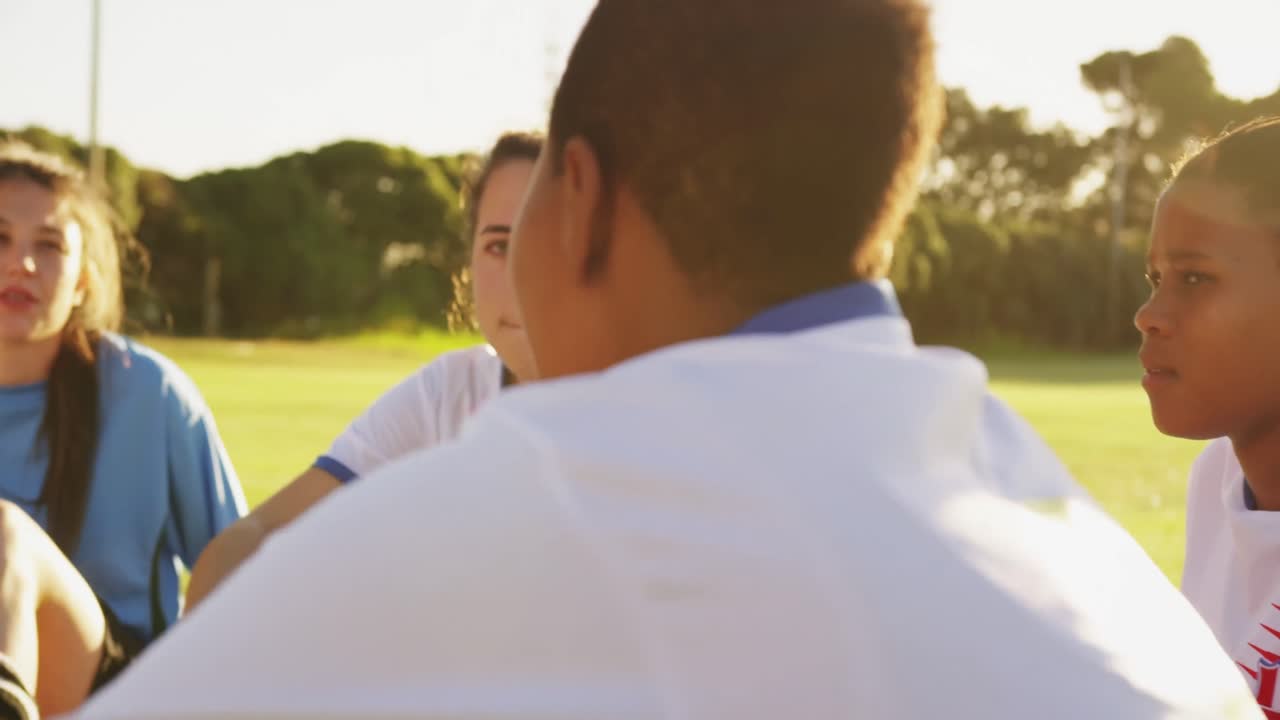 휴식 시간 에 여자 축구 팀 이 축구장 에서 이야기 하고 있다. 4k