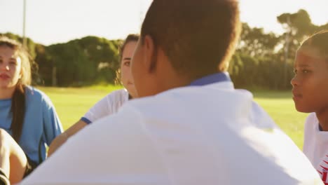 female soccer team in break time talking on soccer field. 4k