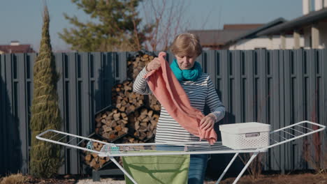 woman drying clothes outdoors