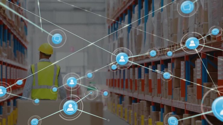 Animation of network of icons over rear view of caucasian male worker pulling a pallet at warehouse