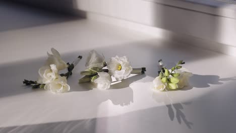 white freesia boutonnieres for a wedding