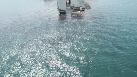 Pan-up-reveal-drone-shot-of-Old-Harry-rocks-from-the-sea